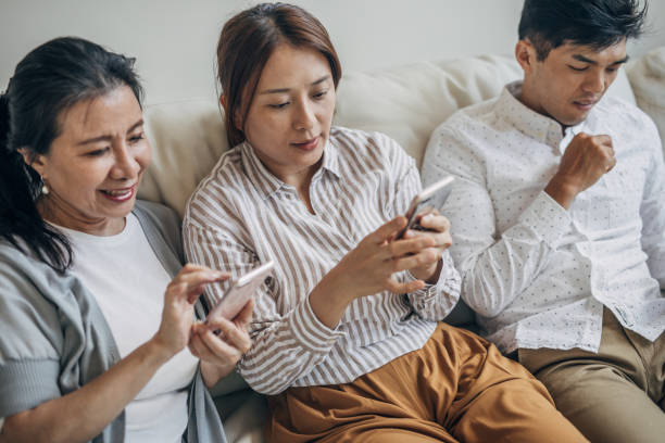 istock Large  family using devices, sitting together 1158001370