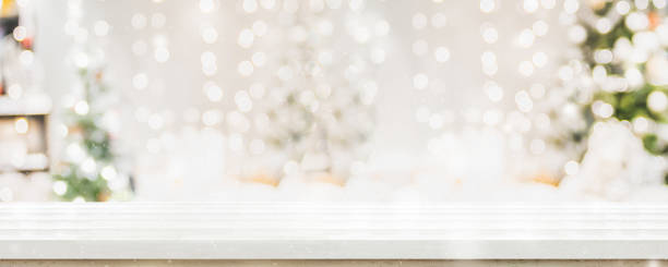 istock Empty white wold table top with abstract warm living room decor with christmas tree string light blur background with snow,Holiday backdrop,Mock up banner for display of advertise product. 1158003384