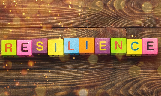 Resilience sign with wooden cubes on background