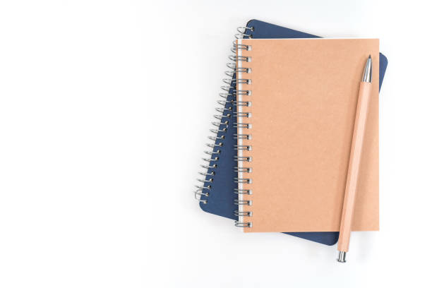 istock Top view blank Wood color diary and pencil on white desk 1158005080