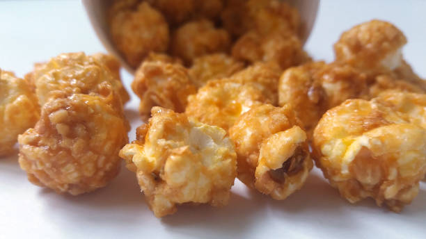 istock Caramel popcorn scattered. Close-up. Background for menu and party banner. 1158005568