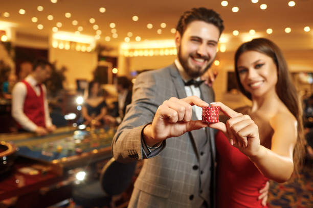 happy couple holding roulette chips in their hands. - smiling casino human hand beautiful imagens e fotografias de stock