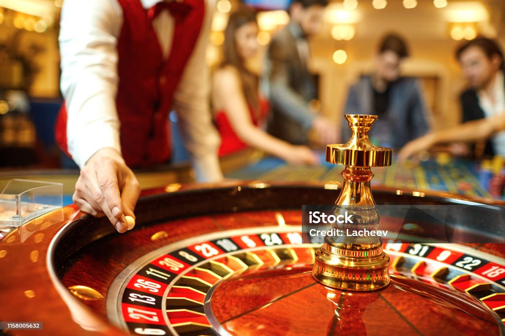 The Croupier Holds A Roulette Ball In A Casino In His Hand Stock Photo -  Download Image Now - iStock