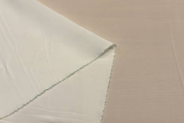 istock Ivory crepe de Chine silk fabric in artistic layout. Texture, background, pattern. 1158006233