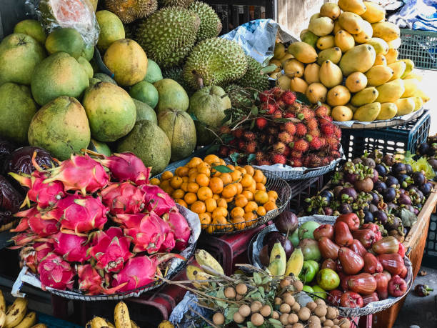 A front view shot of a market stall selling an abundance of fresh fruit.