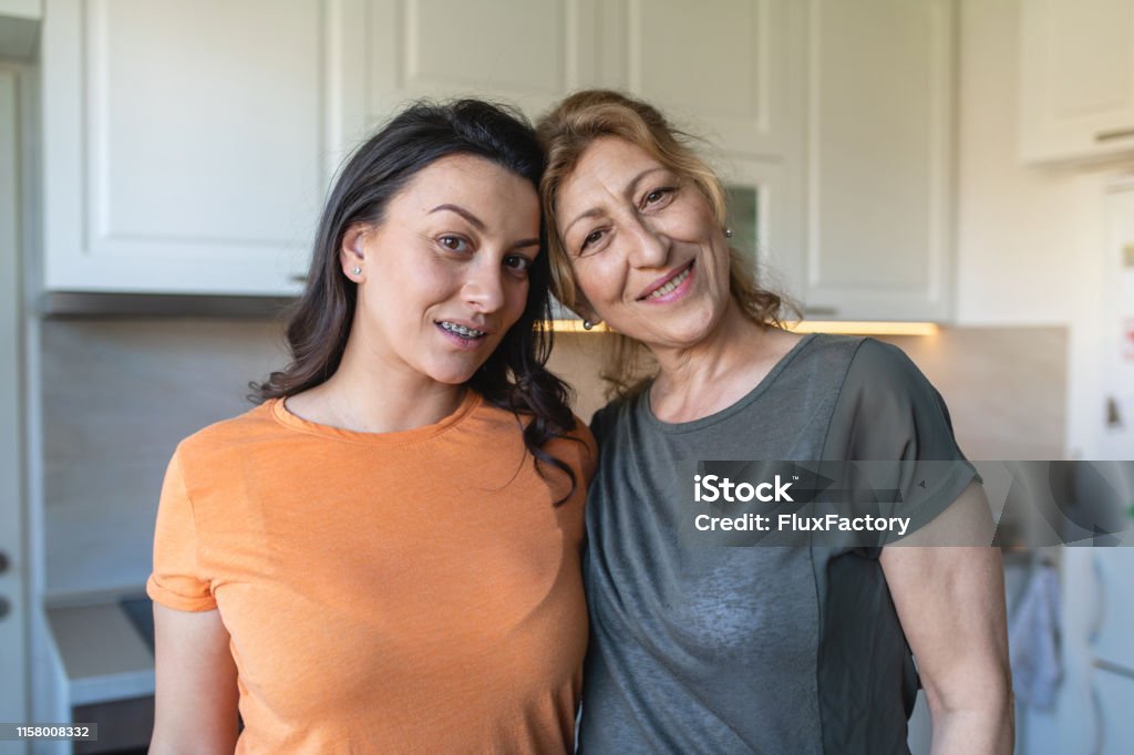 Beautiful mother and daughter Beautiful two generation family of mother and daughter spending time together at home during mother's day. Look-alike Stock Photo