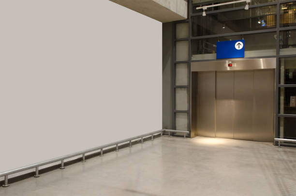istock interior corridor in hall with white wall and elevator in modern office elegant building, subway train station, airport or department store shopping mall, interior and architecture concept 1158008367