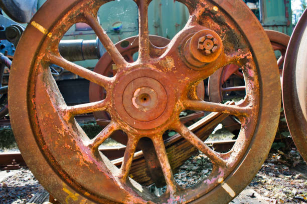 detail of an old rusty weathered iron red wheel of a historic locomotive - metal rusty rust steel imagens e fotografias de stock