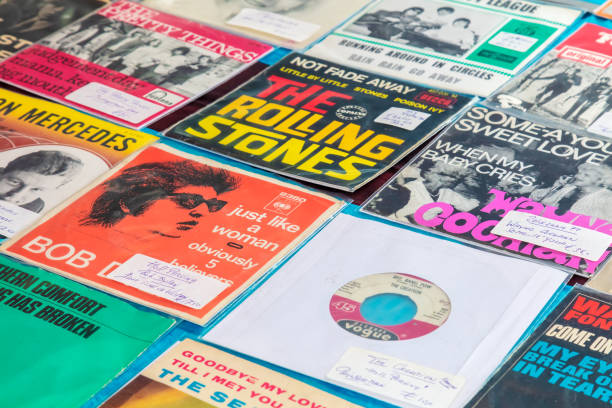 Record store shelf full of vinyl records organized in alphabetical order is ready for customers to browse