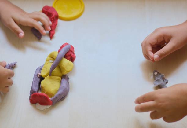 istock kids playing with colorful play doughs 1158011197