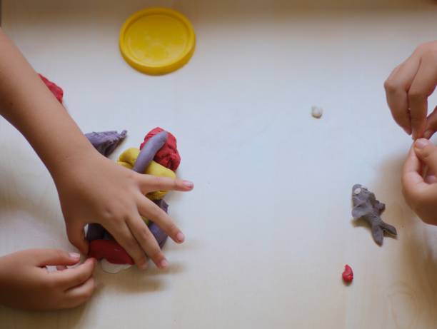 istock kids playing with colorful play doughs 1158011341