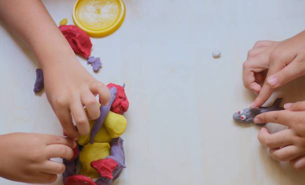 istock kids playing with colorful play doughs 1158011713