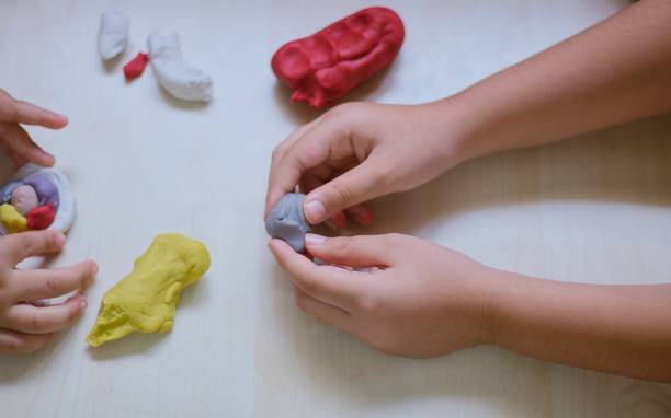istock kids playing with colorful play doughs 1158011879