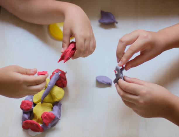 istock kids playing with colorful play doughs 1158012002