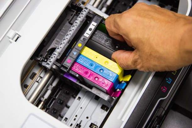 istock Technicians are installing the color printer inkjet cartridge of the printer 1158013259