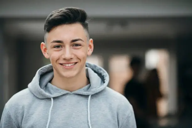 Portrait of a smiling teenager looking at the camera and smiling.