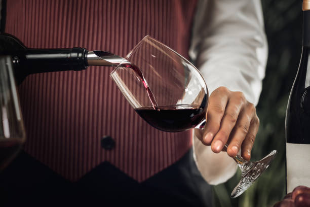 istock Red Wine Pouring Into Wine Glass 1158014358