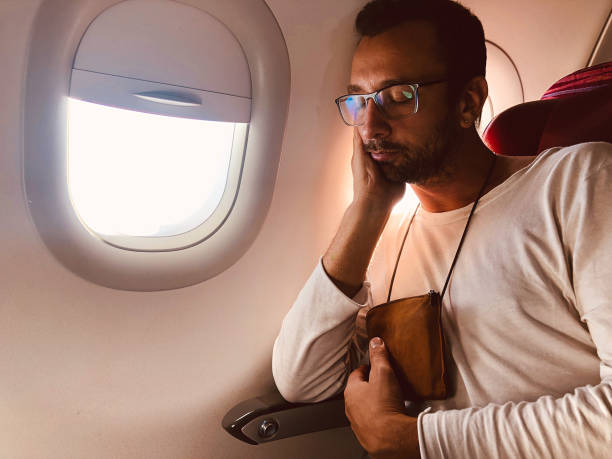 istock Airplane passenger with a neck bag for safe carrying money and documents. 1158016192