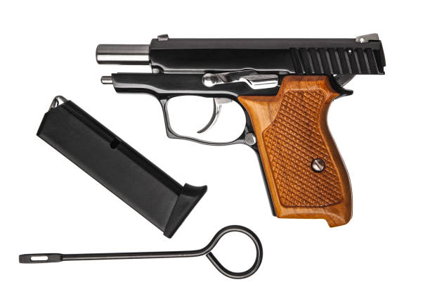 istock A small black pistol with a wooden handle isolate on a white background. 1158017093