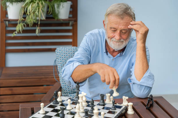 istock Elderly playing chess in nursing home for leisure 1158017571