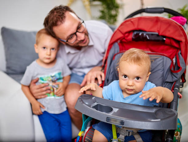 istock Single father playing with his boys at home. 1158019475