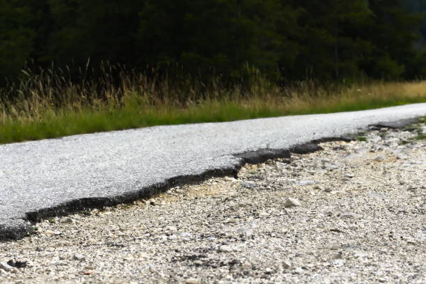 istock Low angle view of Cracked Asphalt Road 1158021141