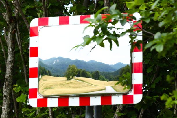 istock Reflection of Rural Landscape in Mirror positioned Next the Road 1158021188