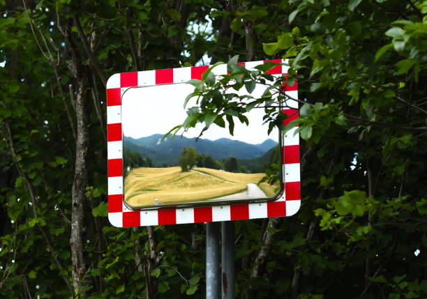 istock Reflection of Rural Landscape in Mirror positioned Next the Road 1158021196