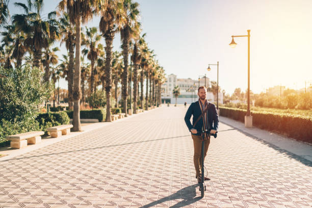 istock Businessman riding an electric push scooter on his way to work 1158022307