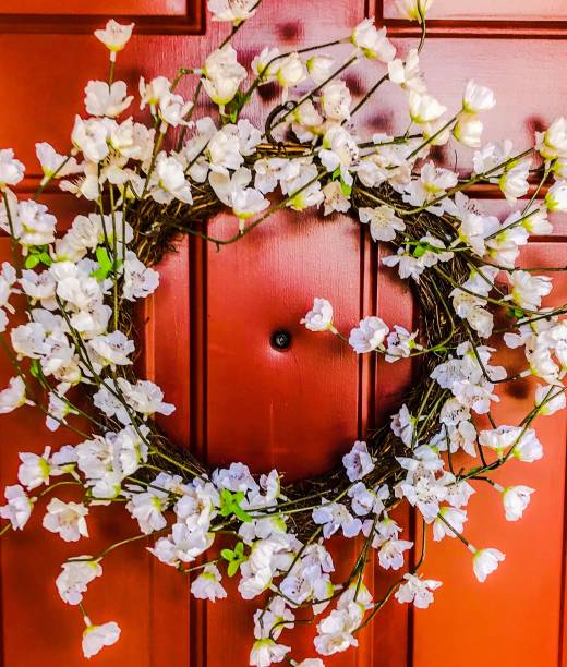 istock Flowery wreath on a  red orange door 1158022601
