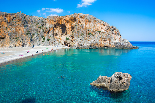 Agiofarago beach with natural caves and stone arches at the end of the gorge in Crete island, Greece