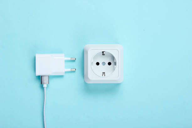 istock Charger and power outlet on blue background 1158025226