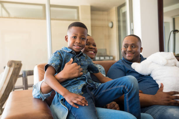 istock Parents with children relaxing on sofa at home 1158025626