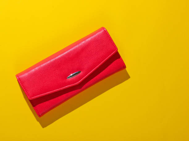 istock Red leather wallet on yellow background. Top view 1158026691