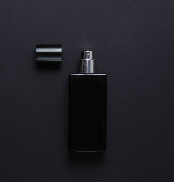 istock Bottle of male perfume on black background. Top view 1158026992