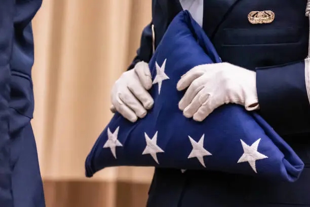Honor Guard with a folded American flag.