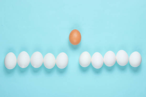 istock Bullying concept with eggs on a blue background. Top view, minimalism 1158027799
