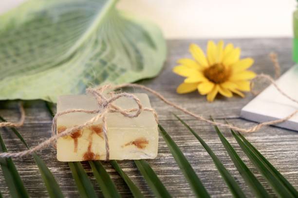 istock Natural soap, leaves, flowers on a wooden table 1158028548