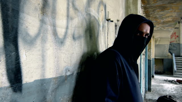 Man With Mask And Hoodie Looking At The Camera
