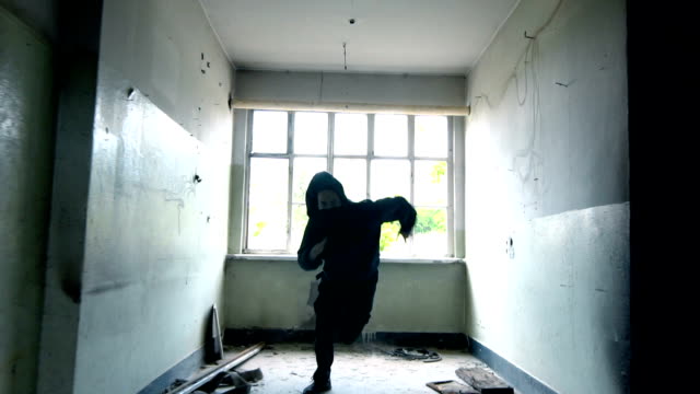 Man With Mask and Hoodie Running Towards The Camera