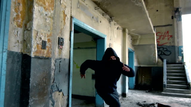 Man With Mask And Hoodie Running Toward The Camera