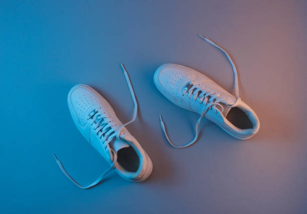 istock White sneakers with neon light. Top view. Minimalism 1158031173