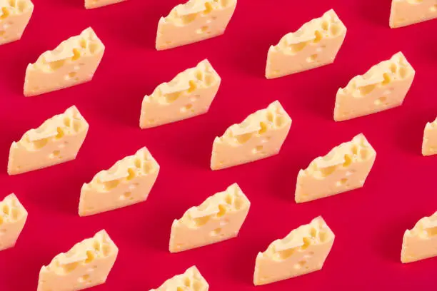 Photo of Cheese pattern on red background