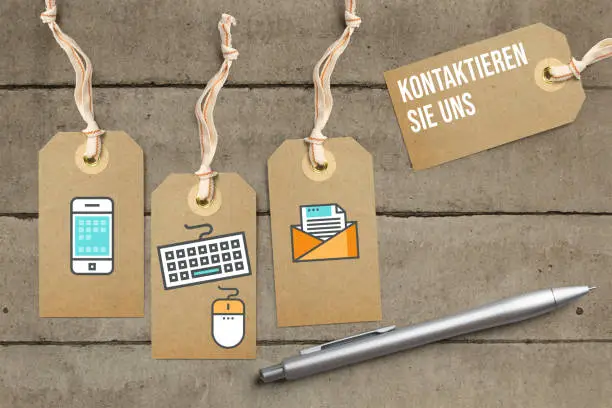 hangtags with contact options as icons and message "contact us" in German on solid background