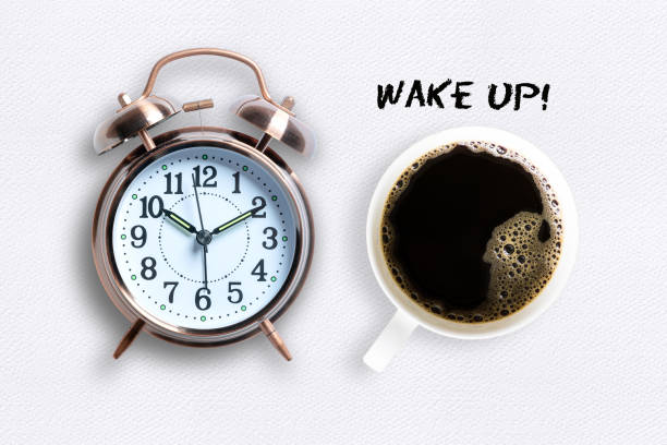 istock Mug of coffee and alarm clock in Wake Up concept 1158032983