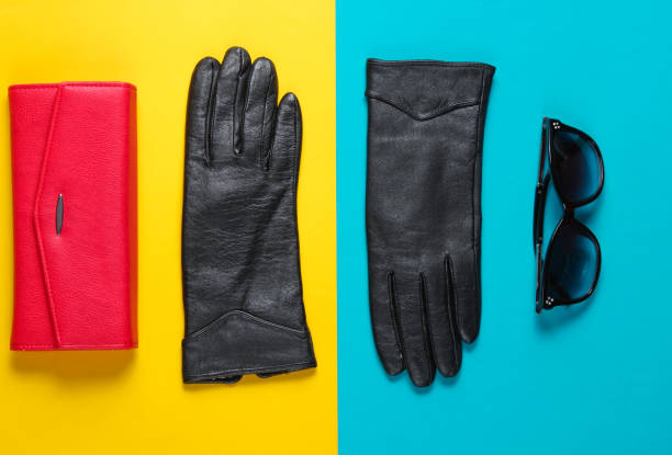 istock Red leather wallet, sunglasses, gloves close-up on colored background. Top view 1158033043