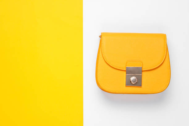 istock Leather yellow bag on a colored background. Top view, minimalism 1158033380
