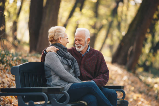 istock Happy autumn senior couple on park bench 1158034063