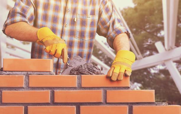 Masonry. Portrait of young profession man at work on background hand with a plaster spatula stock pictures, royalty-free photos & images