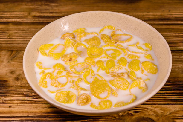 istock Ceramic plate with cornflakes and milk on a wooden table. Healthy eating 1158038399
